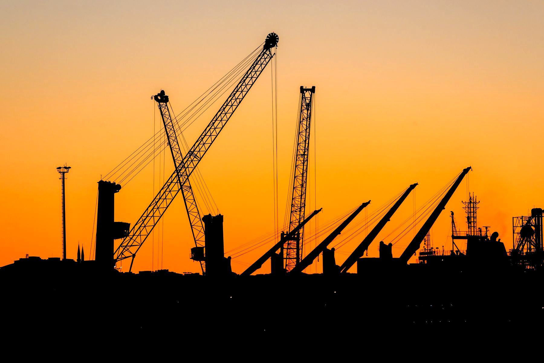 Gru da cantiere in controluce al tramonto